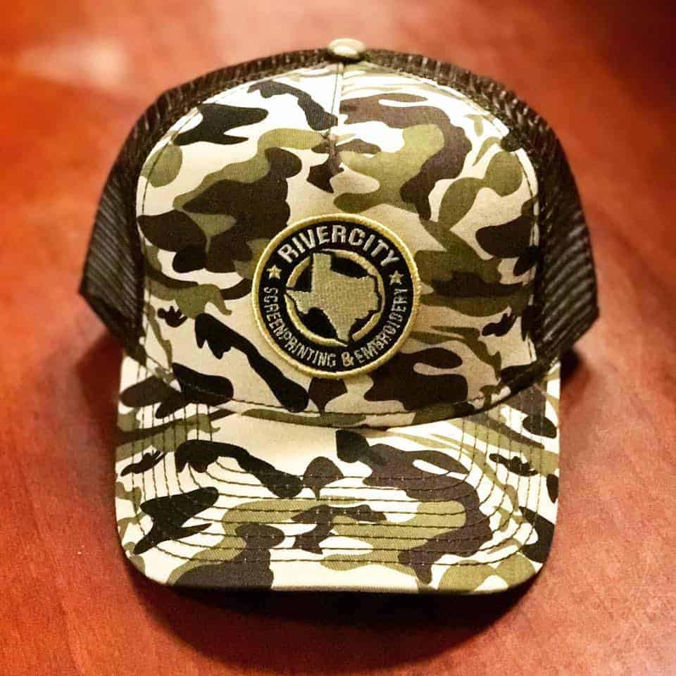 A custom-embroidered hat with a camo print.